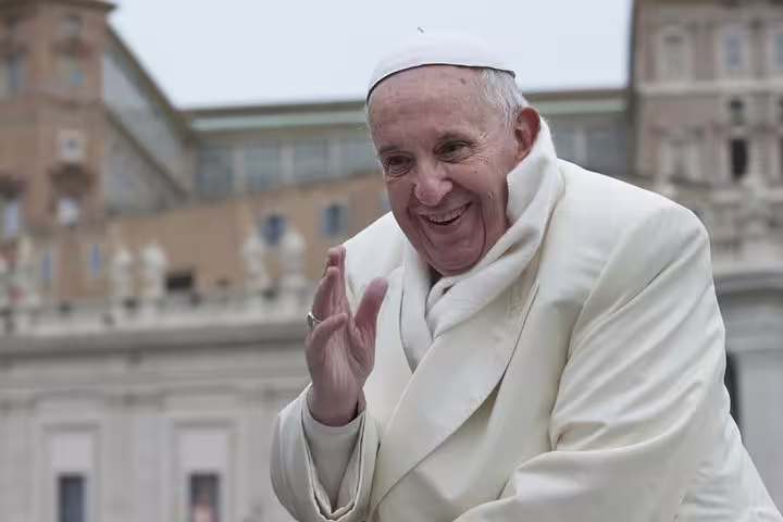 Smiling Pope greeting pilgrims during Vatican Papal Audience, a highlight of skip-the-line tour to St Peter’s and Sistine Chapel