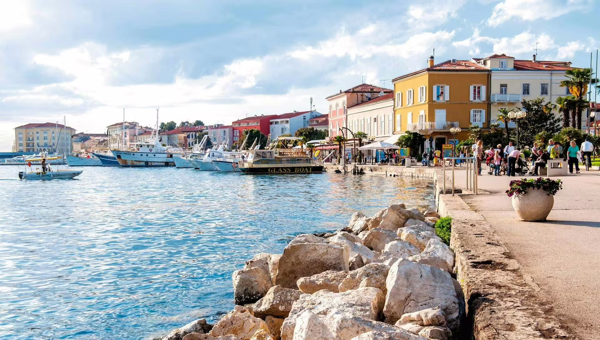 Poreč waterfront promenade with boats and pastel buildings on the Ancient Istria day trip from Pula