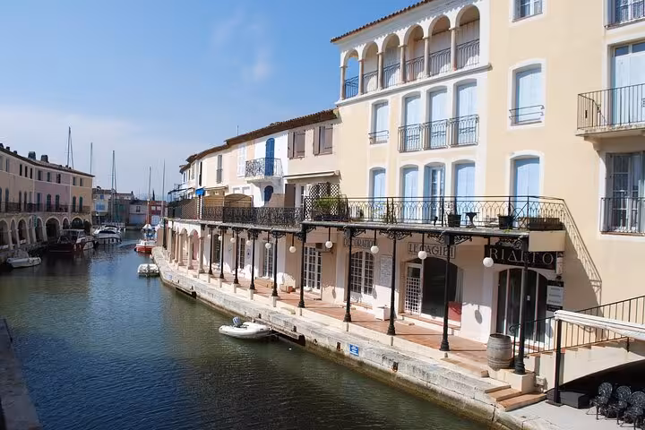 Charming canal view in Port Grimaud with colorful Mediterranean-style buildings and moored boats.
