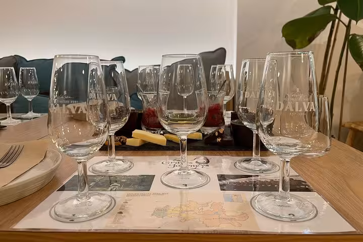Close-up of Port wine flight glasses on tasting mats, ready for a sommelier-led 5 Port wines experience with cheese bites