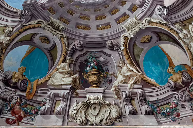 Baroque frescoed dome and stucco angels inside Portici Palace, a highlight of the luxury wine tasting experience