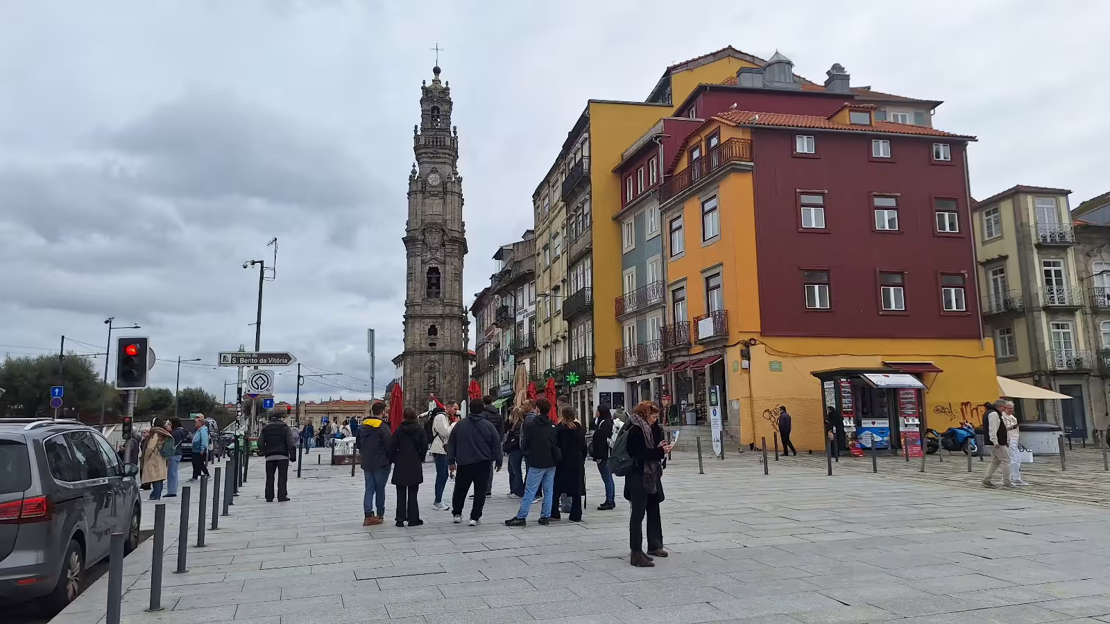 Tourists explore Porto's vibrant streets near Clérigos Tower on a guided afternoon tour by local experts.