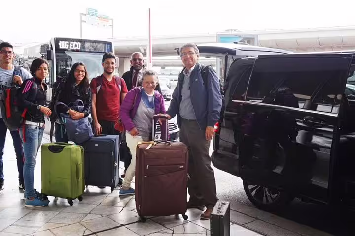 Group of travelers with luggage enjoy convenient private airport transfer service in Porto.