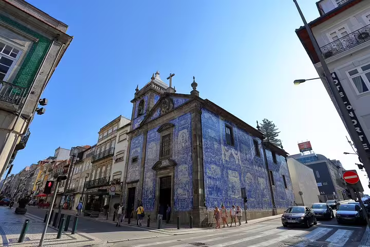 Azulejo-tiled church facade in Porto, showcasing iconic Portuguese architecture on a Lisbon day trip.