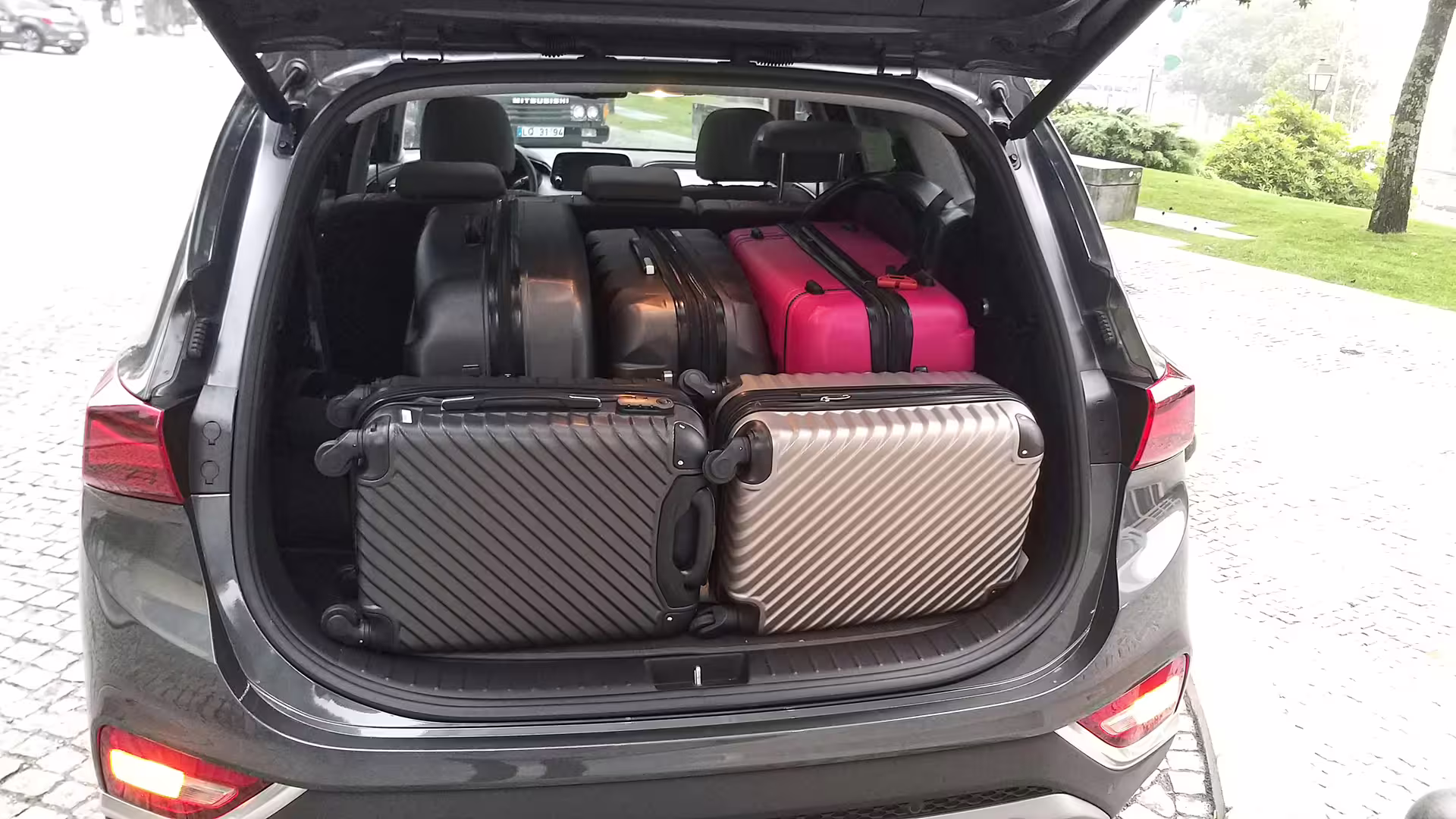 Car trunk loaded with multiple suitcases, showcasing ample luggage space for Porto to Castelo Branco transfer.