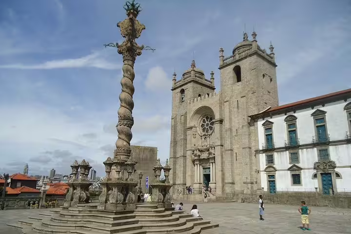 The majestic Porto Cathedral and its striking Gothic architecture under a clear blue sky on a city tour.