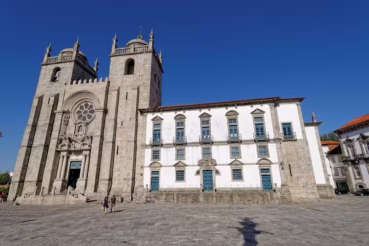 Stunning Porto Cathedral facade under clear blue skies, a highlight of the Porto half day tour.