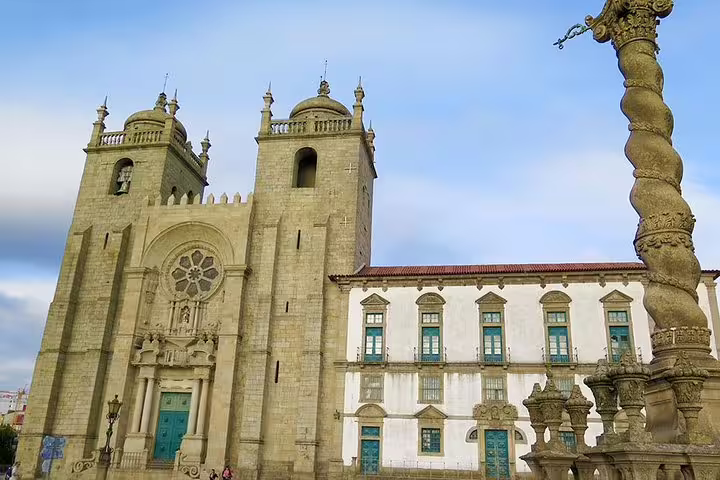 Historic Porto Cathedral with ornate architecture under a blue sky, featured in a private tour from Lisbon to Porto.