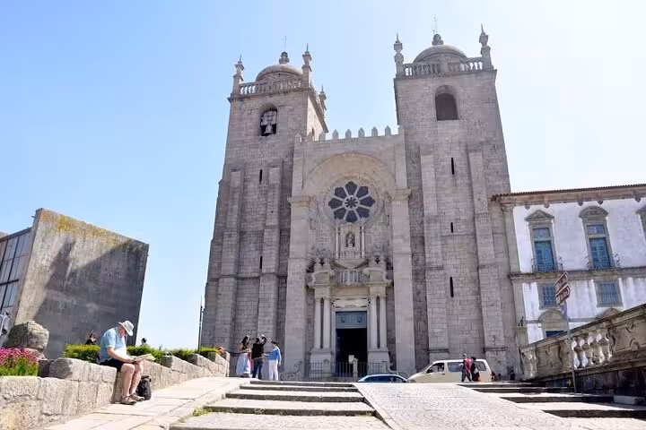 Front view of Porto Cathedral's grand facade, an iconic stop on the Lisbon to Porto private Mercedes transfer tour.