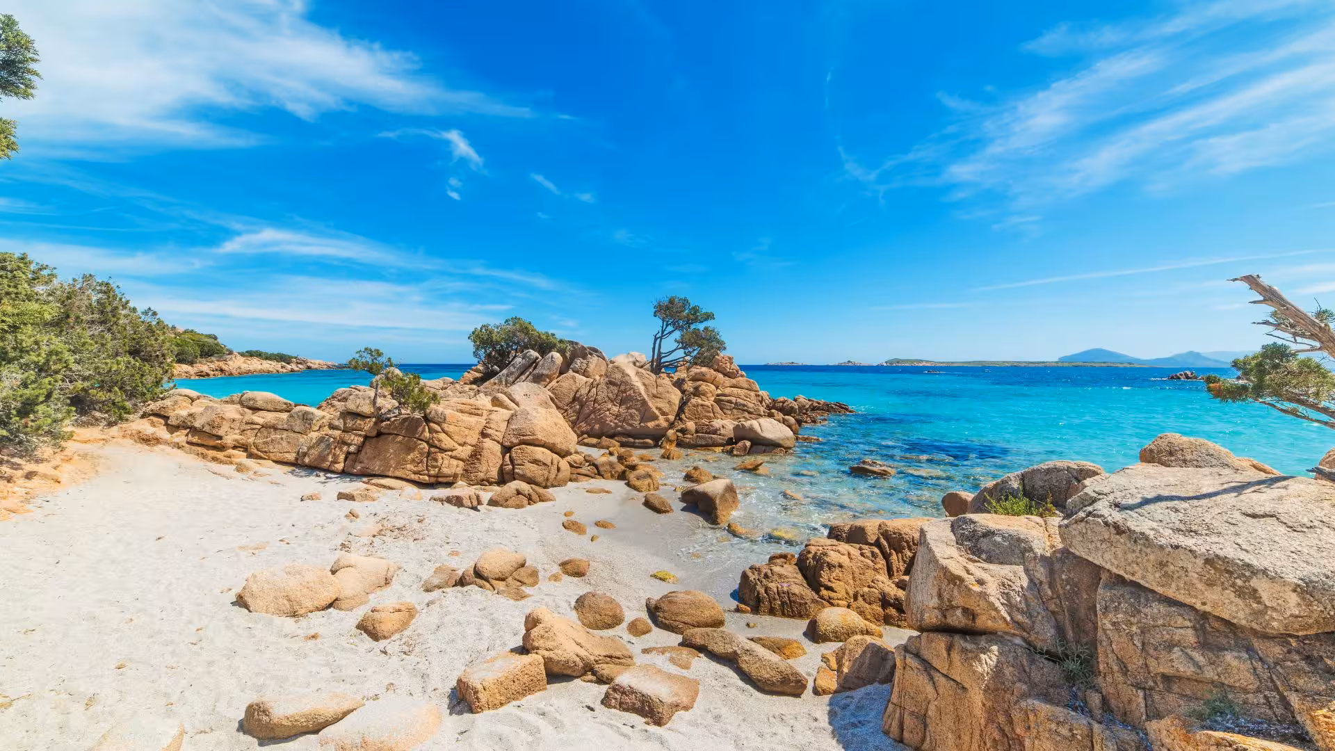 Stunning view of Porto Cervo's rocky coastline with clear turquoise waters, ideal for a scenic dinghy tour.