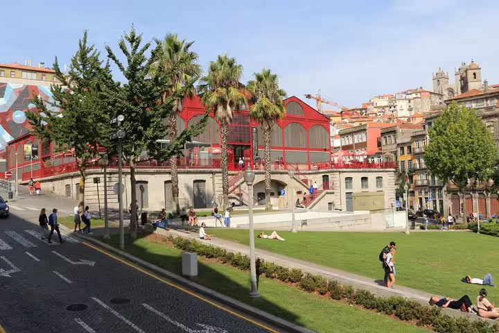 Relax in Porto's vibrant market area and green spaces on a city tour with winery visits and scenic river cruise.