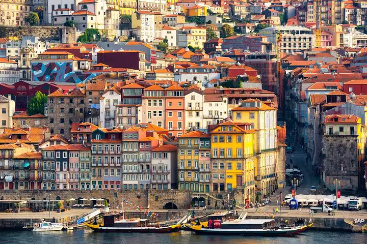 Vibrant view of Porto's colorful riverside architecture along the Douro River, ideal for a memorable Lisboa to Porto day tour.