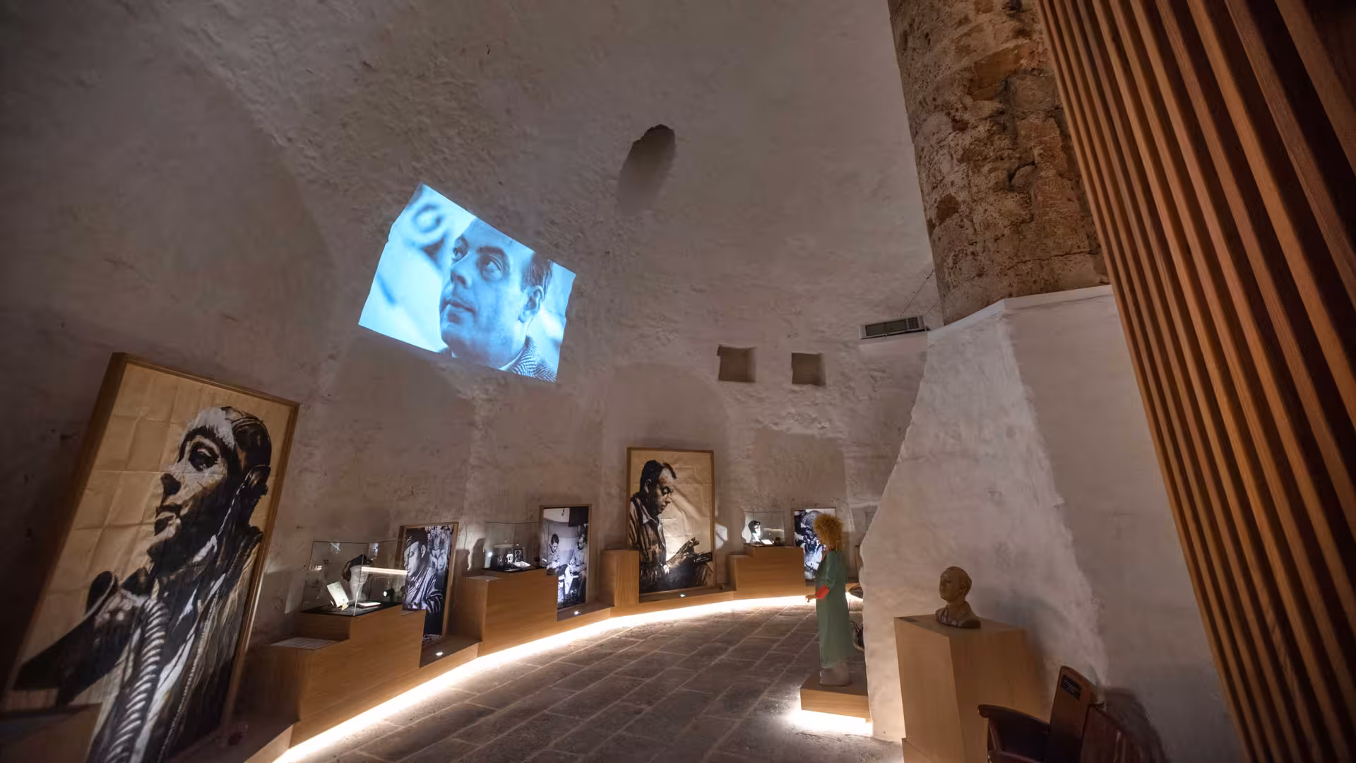 Ecomuseum room at Porto Conte Park showcasing art and projections, highlighting Alghero's cultural heritage.
