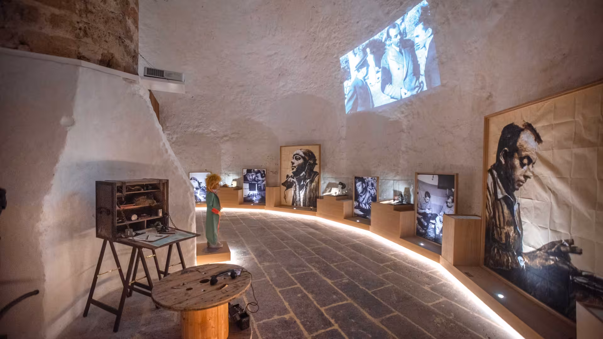 Interior of Porto Conte Park Ecomuseum featuring historical displays and multimedia projections in Alghero.