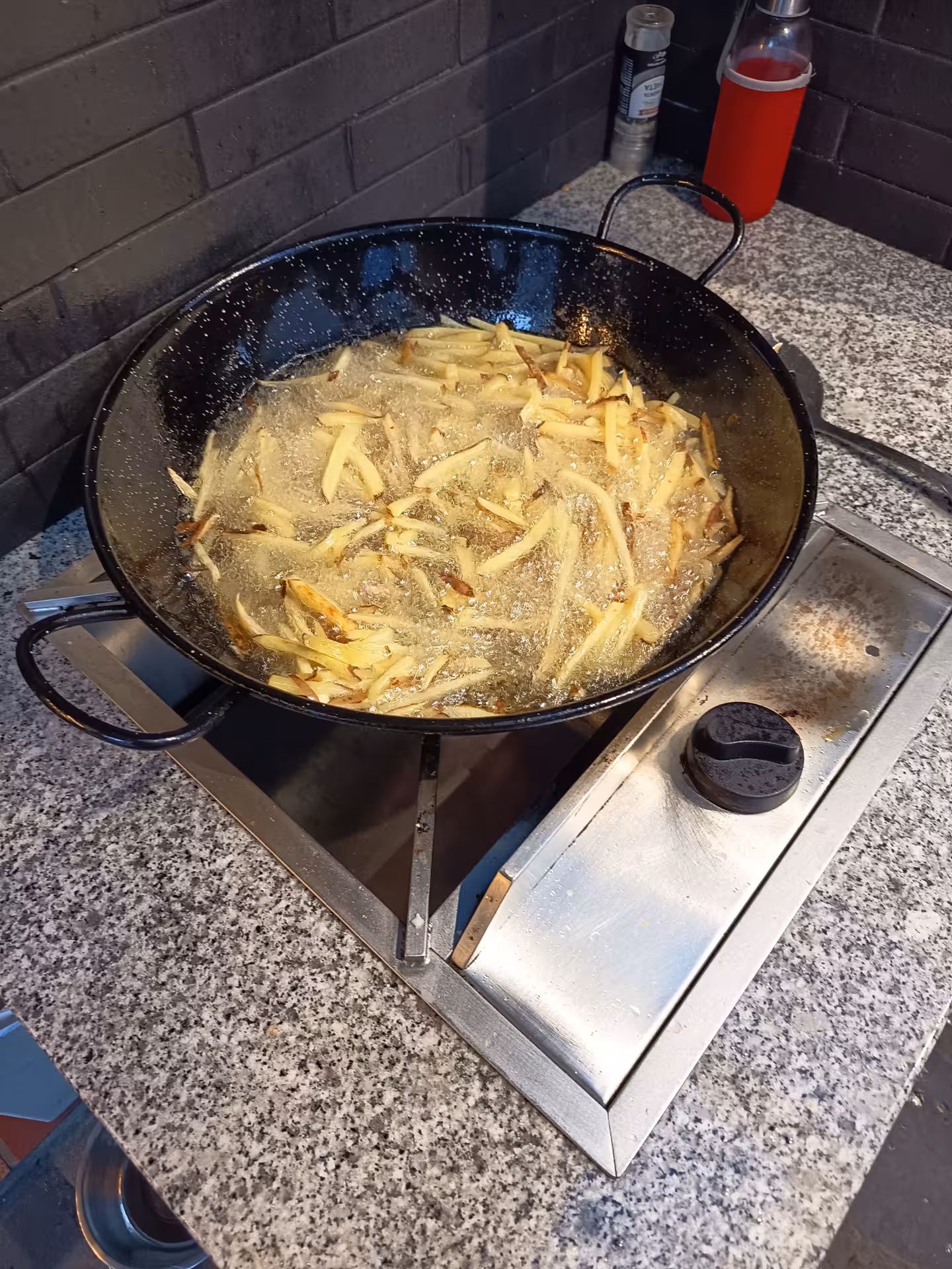 Crispy golden fries sizzling in a pan during a Porto cooking class with Jorge and Isabel.