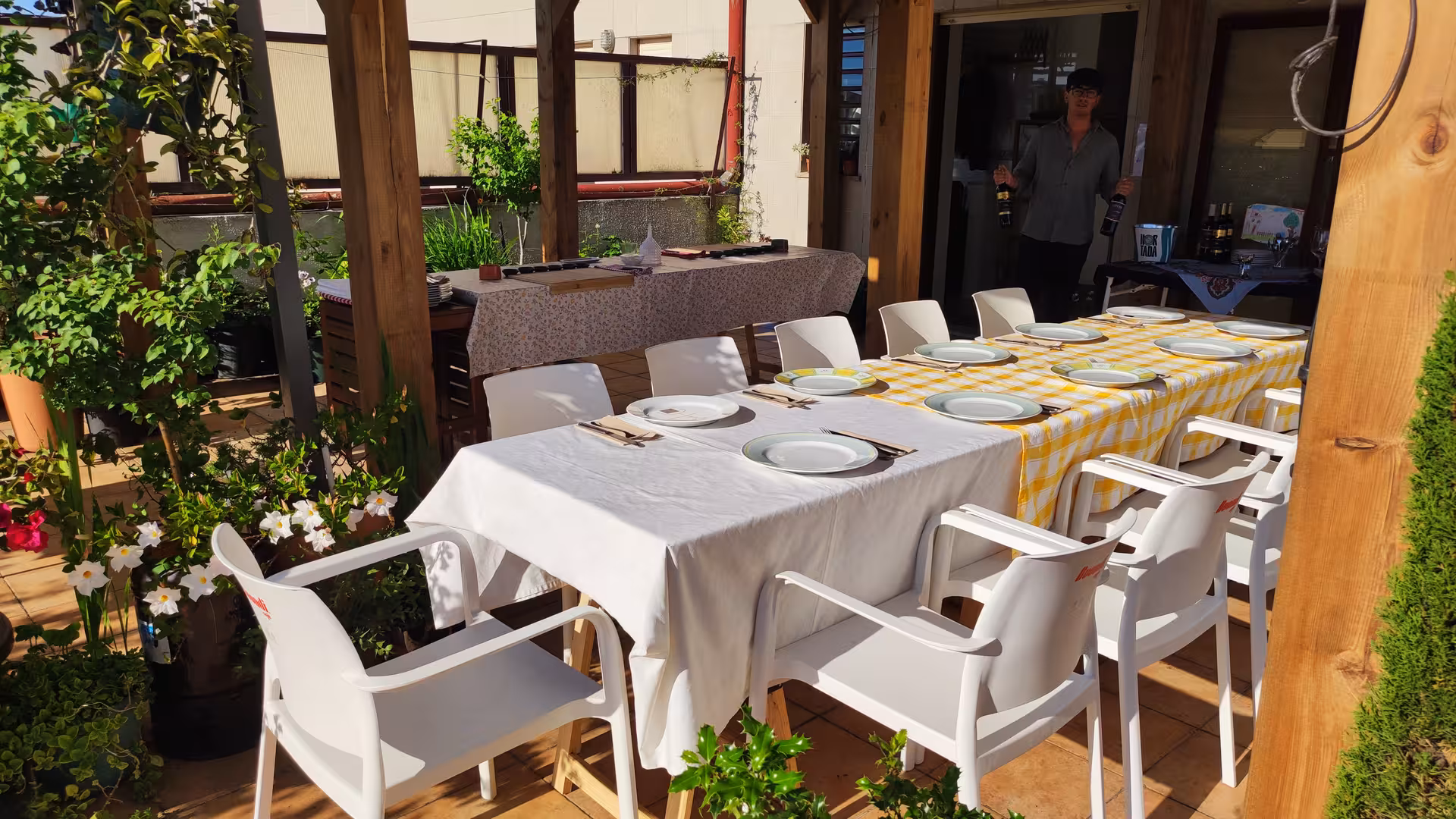 Beautifully set outdoor dining area ready for guests at the Porto Cooking Class with Jorge and Isabel, surrounded by lush greenery.