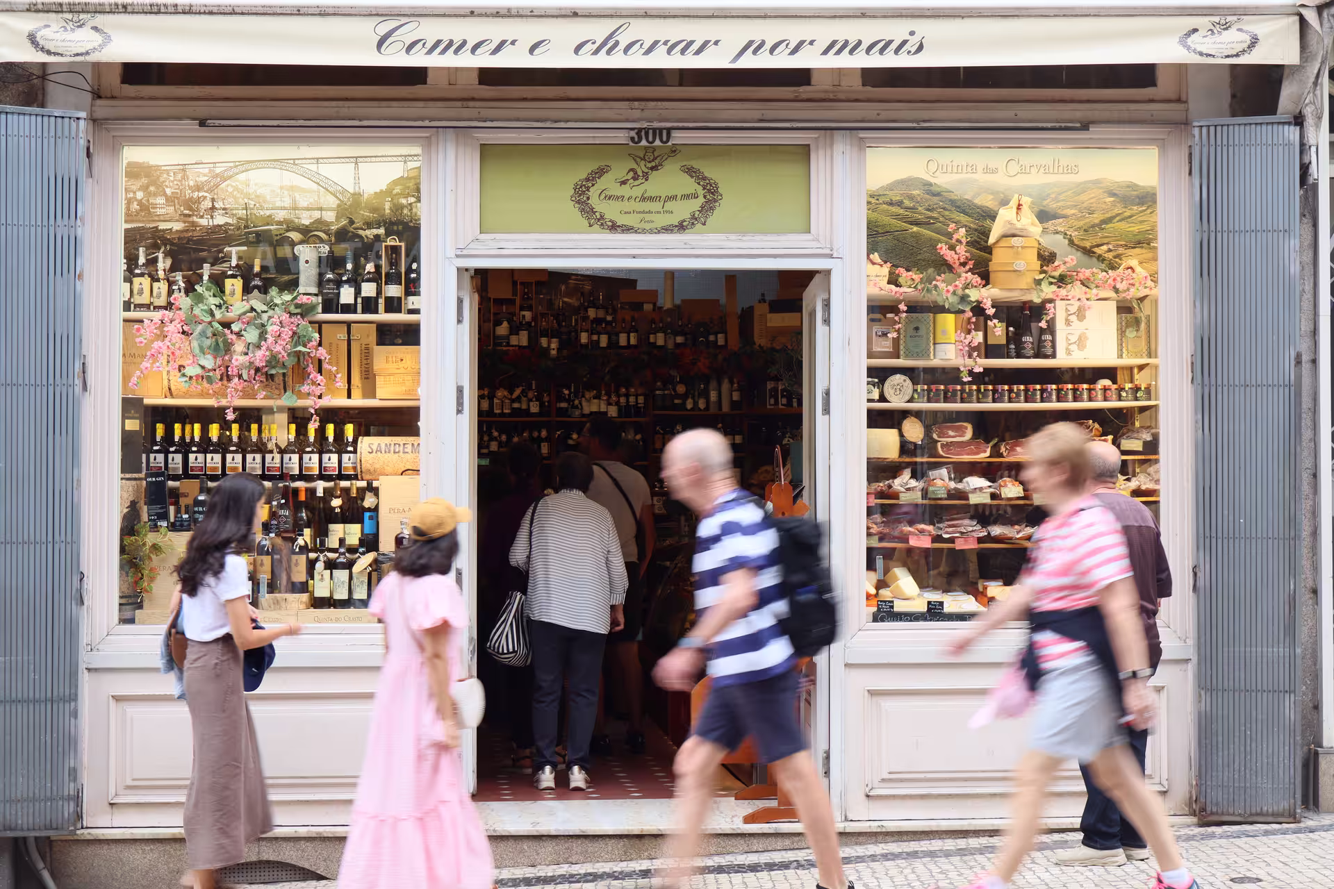 Charming Porto deli storefront showcasing local wines and delicacies on a private food tour in Portugal.