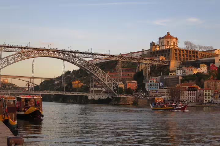 Scenic view of Porto's Dom Luís I Bridge at sunset, ideal for a private half-day tour with wine tasting.