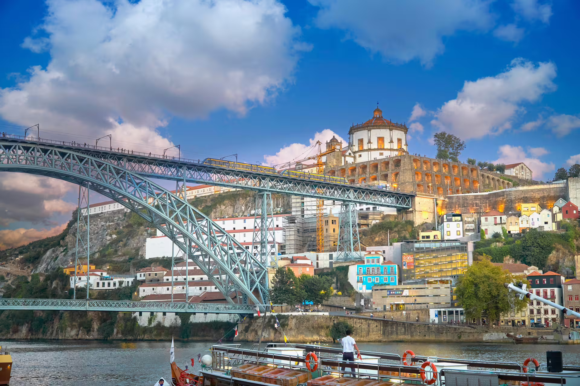 View of Porto's iconic Dom Luís I Bridge and riverside architecture, perfect for a scenic guided tuk tuk tour in Portugal.