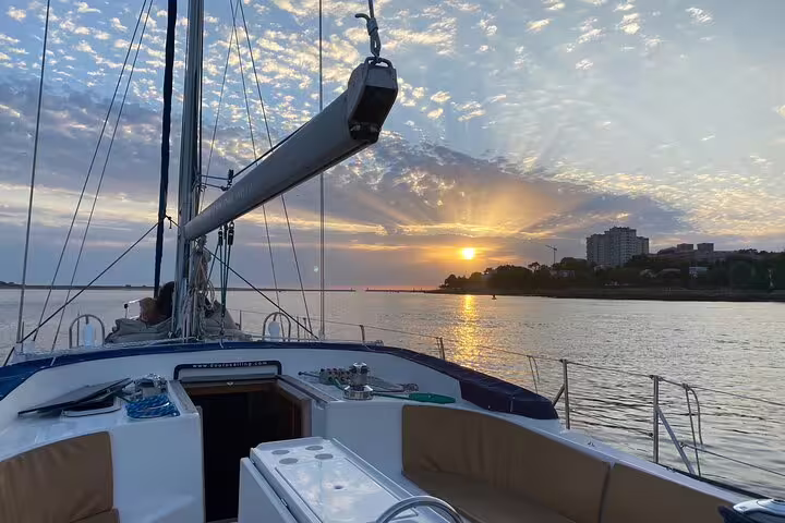 Sail along the Douro River at sunset on a Porto boat tour with included wine and snacks, offering stunning views and relaxation.