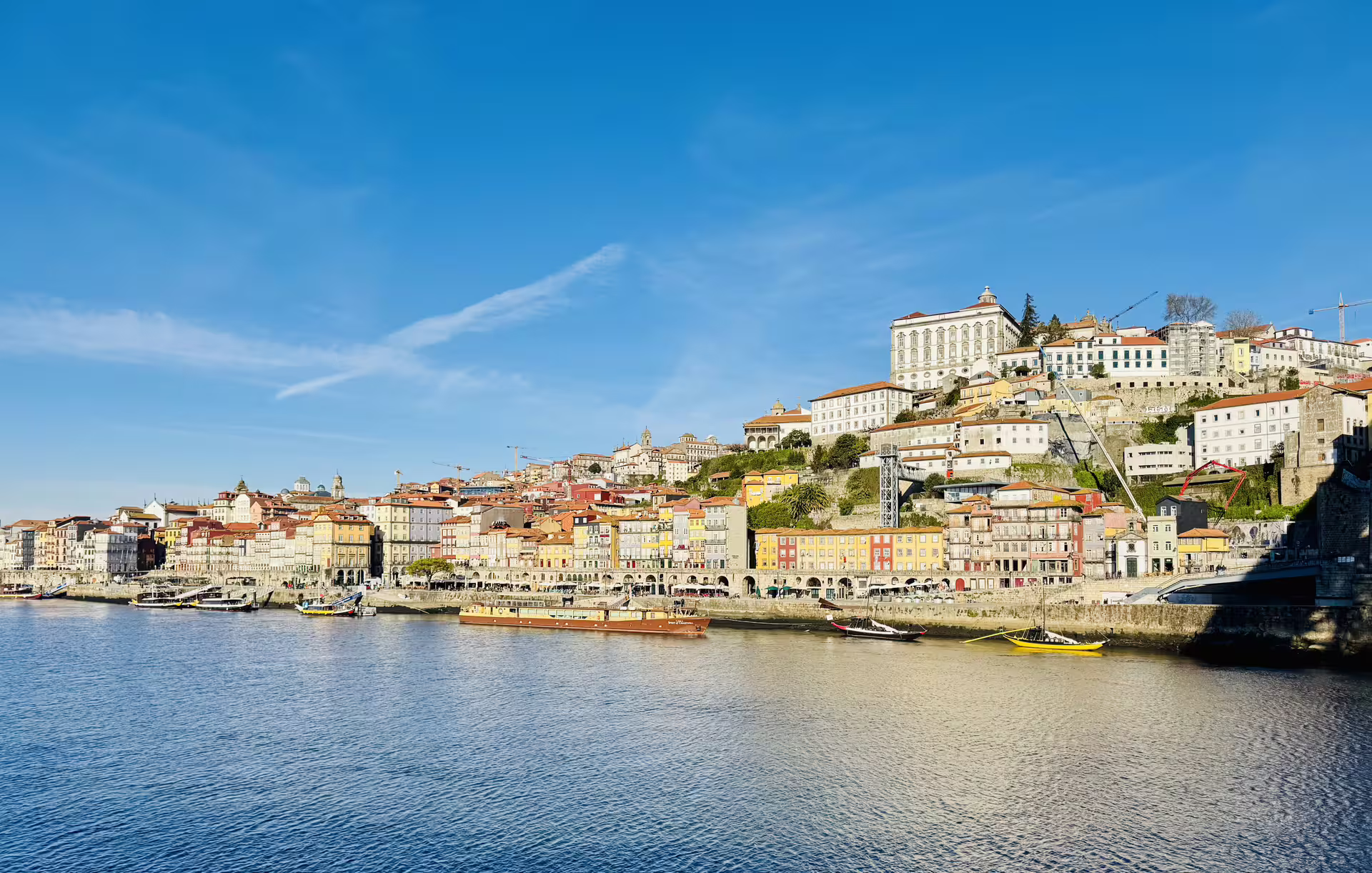 View of Porto's colorful riverside buildings along the Douro River, perfect for exploring on the Porto and Gaia walking tour.