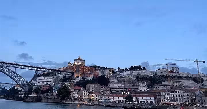 Porto and Vila Nova de Gaia skyline from the Douro River, with Dom Luís I Bridge on a vintage car tour