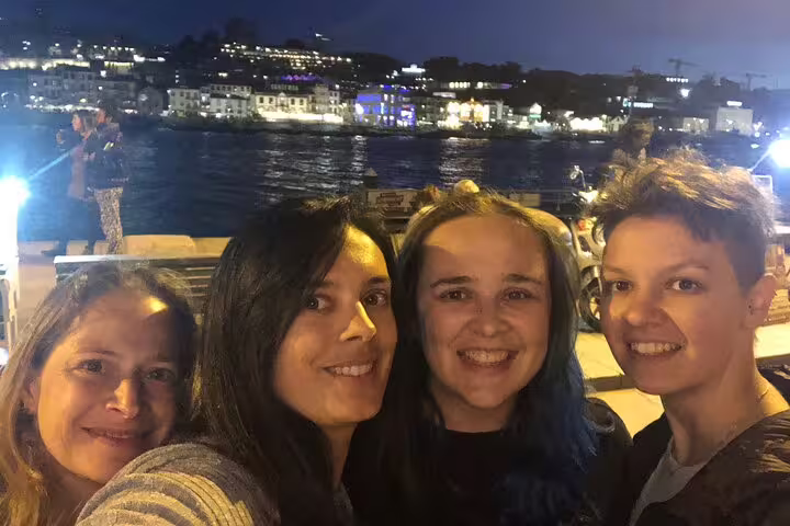 Night selfie on Douro River promenade with Porto lights, ideal for a Porto self-guided scavenger hunt tour