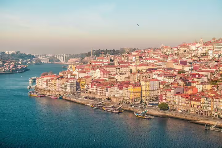 Scenic view of Porto's colorful riverside architecture along the Douro River, ideal for a full-day private tuk tuk tour.