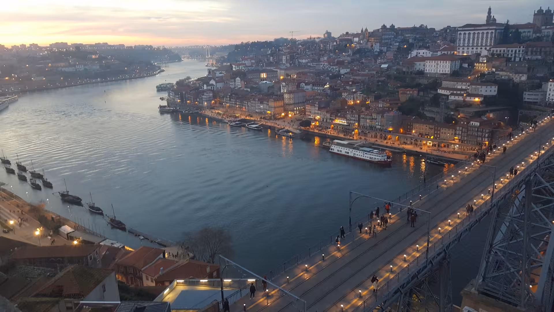 Douro River and Ribeira waterfront from Dom Luís I Bridge at dusk, private half-day Porto tour boat cruise