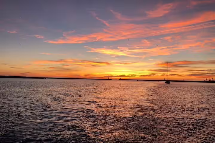 Breathtaking sunset view over the Douro River with vibrant orange and pink hues reflecting on the tranquil water.