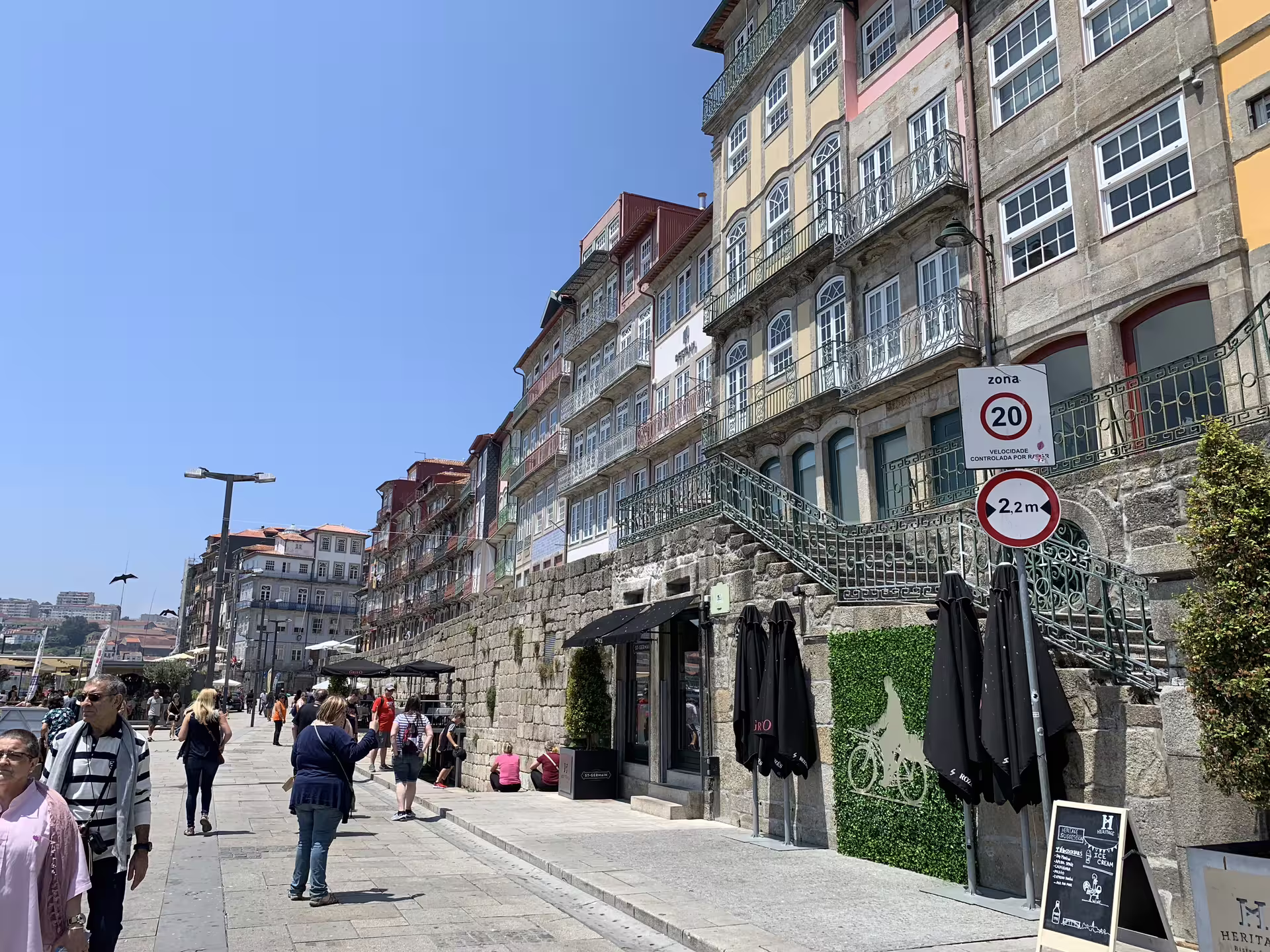 Tourists explore the picturesque streets of Porto's riverside, capturing the vibrant architecture and lively atmosphere of the Douro.