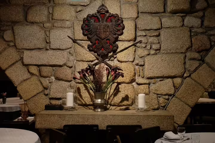 Cozy Portuguese restaurant interior with stone walls and traditional decor, perfect for a Porto moonlight walk and Fado dinner experience.