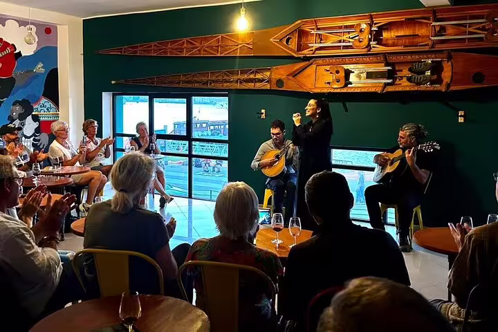 Intimate Fado performance at Porto's riverfront with audience enjoying traditional Portuguese music and ambiance.