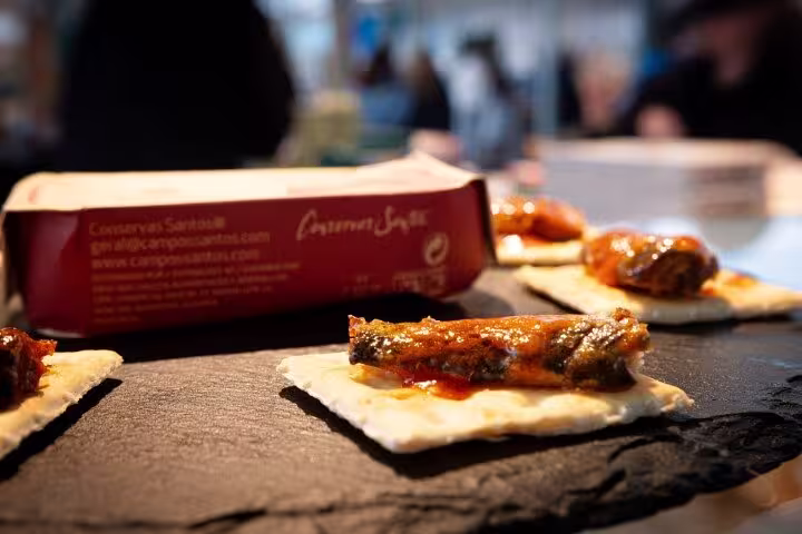 Gourmet sardines on crackers showcased on a Porto food tour, highlighting Portuguese seafood delicacies.