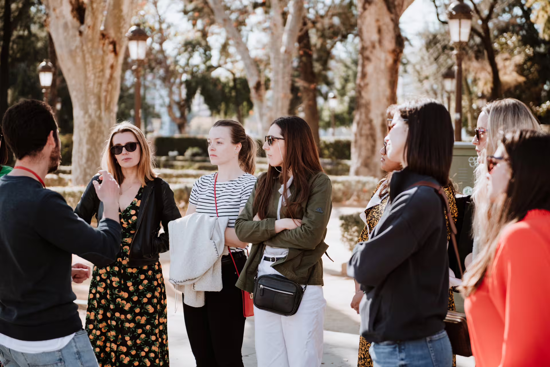 A group of tourists listens to a guide during the Porto and Gaia walking tour along the scenic Douro riversides.