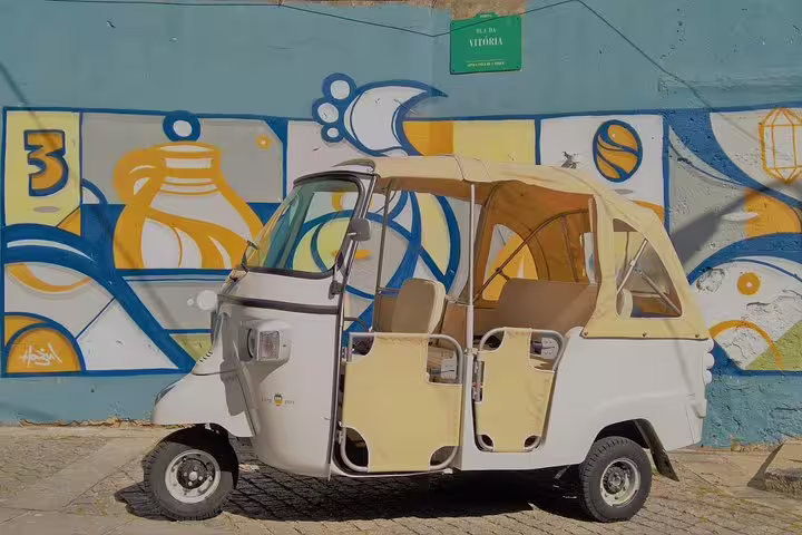 Explore Porto's vibrant streets on a guided tuk tuk tour, featuring colorful street art and local culture highlights.