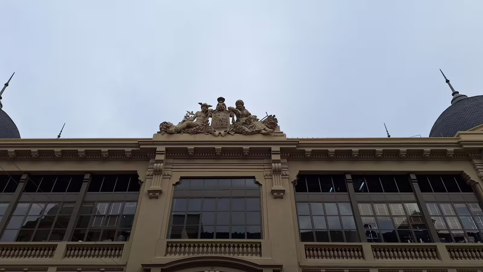 Ornate architectural detail of a historic building in Porto, showcasing classical sculptures on a private morning tour.
