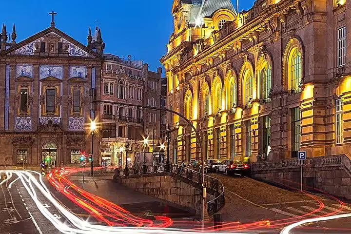 Night view of Porto's illuminated historic buildings and bustling streets, capturing the vibrant city atmosphere.