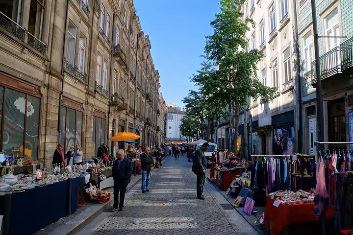 Charming market street in Porto's historic center bustling with vendors and visitors, a highlight on e-bike tours.