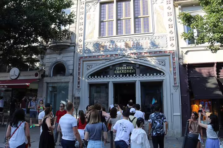 Tourists entering Livraria Lello in Porto, a must-visit on the full day city tour and six bridges cruise itinerary.