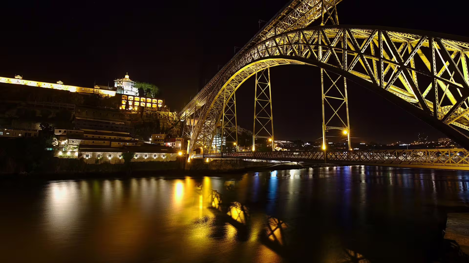 Night picture of the Porto Luis I Bridge and Serra do Pilar Monastery illuminated, part of Cooltour Oporto's Night Tour
