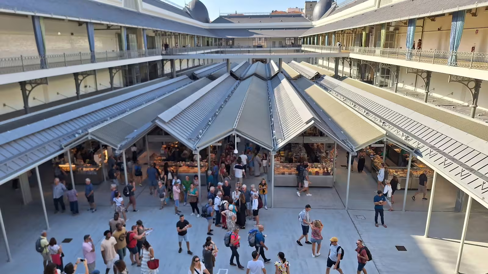 Vibrant morning activity at Mercado do Bolhão in Porto, Portugal, showcasing bustling stalls and architecture on a private tour.