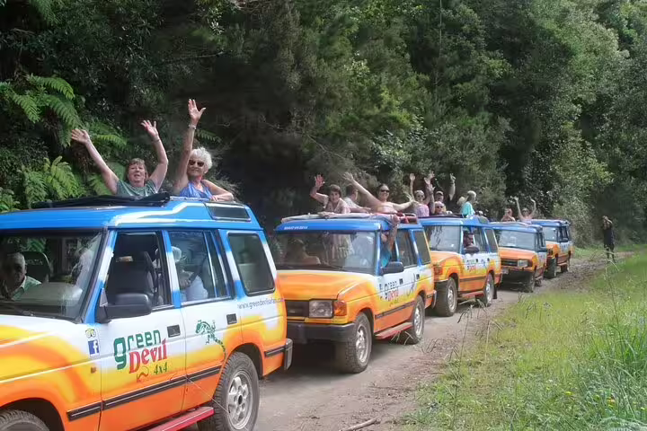 Tourists enjoy an exciting jeep safari through lush landscapes on a full-day Porto Moniz adventure with local guides.