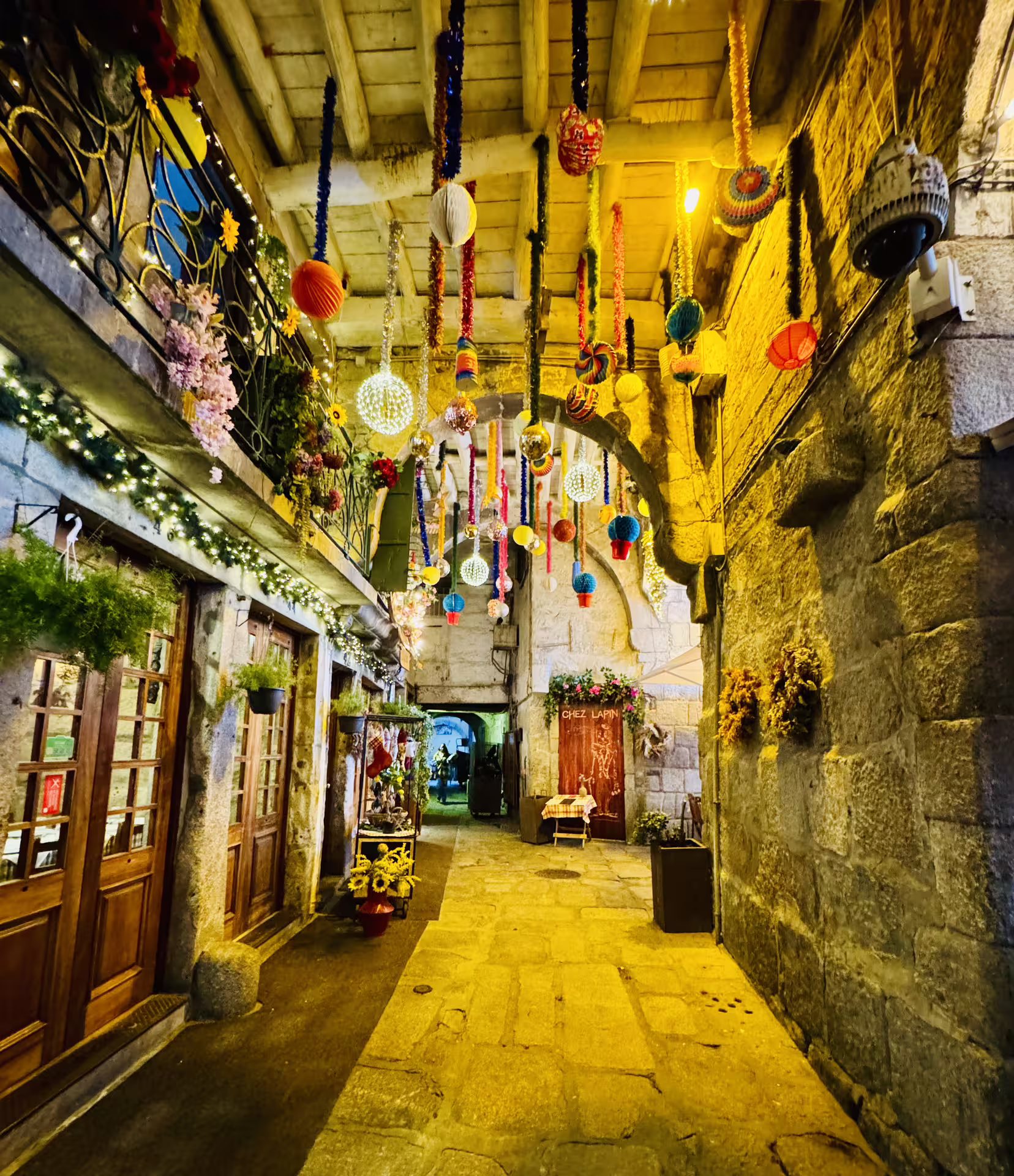 Charming Porto old town alleyway adorned with colorful hanging decorations, ideal for small-group walking tours and river cruises.