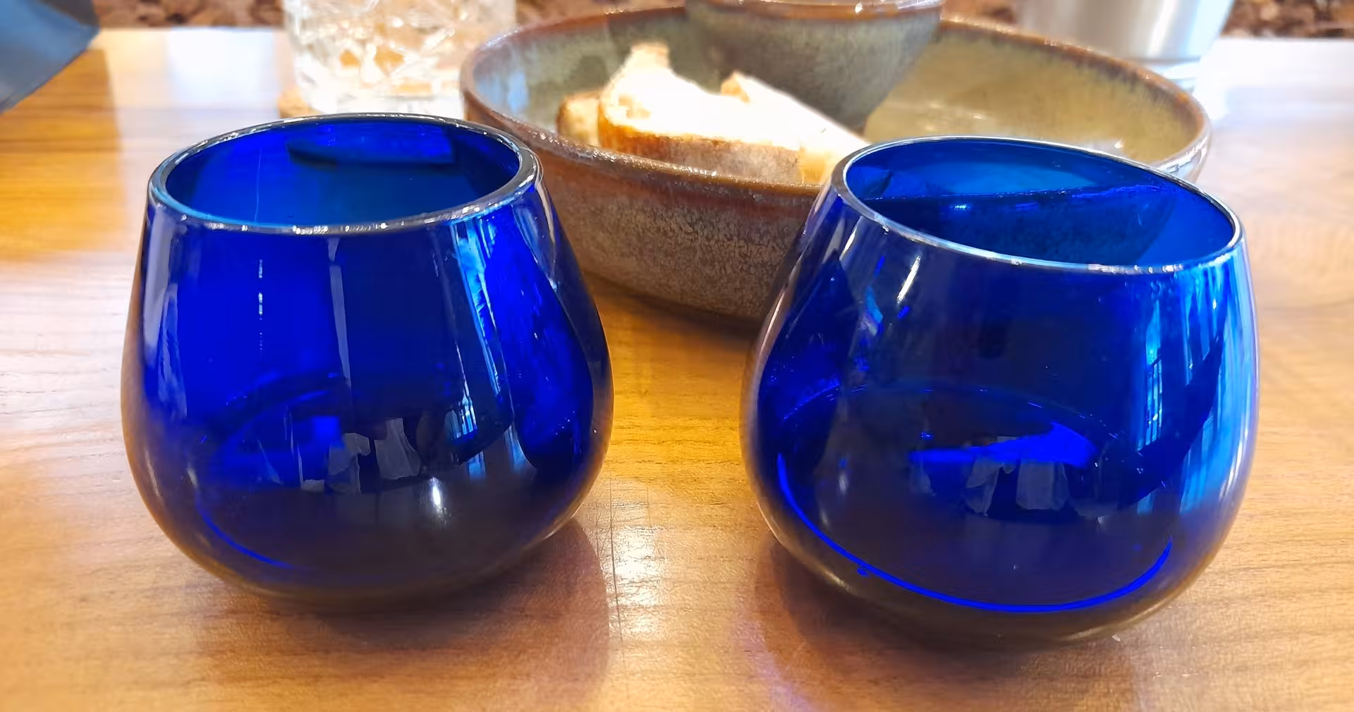 Blue tasting glasses and bread on table during Porto olive oil tasting tour with a local guide