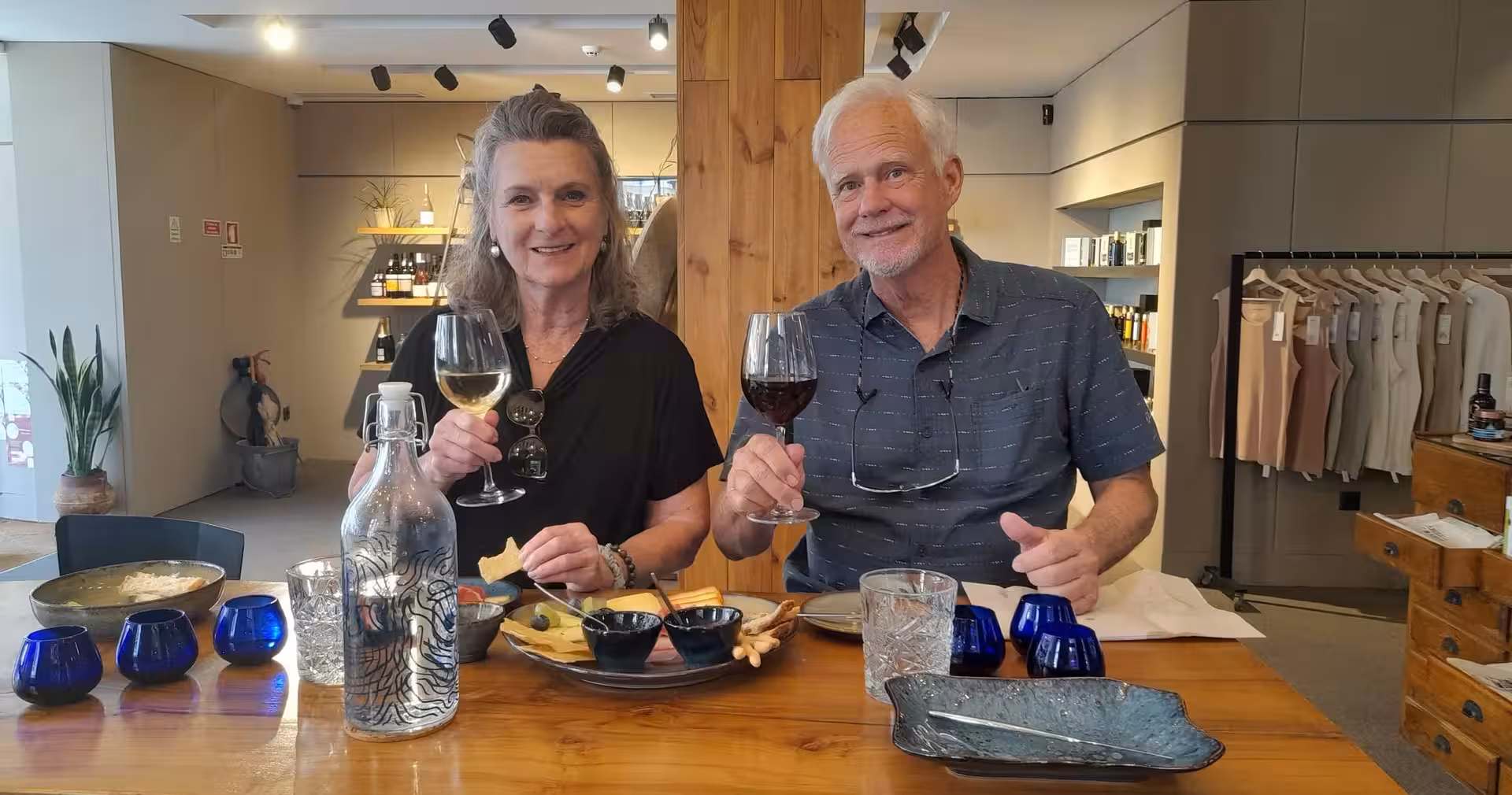 Guests sampling extra virgin olive oil with local guide in Porto tasting room, bread and glasses on table