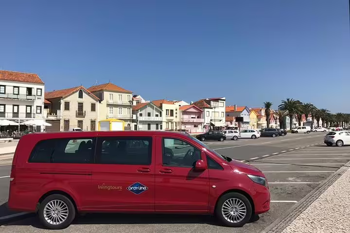 Red private transfer van parked in scenic Porto, showcasing convenient airport departure service.