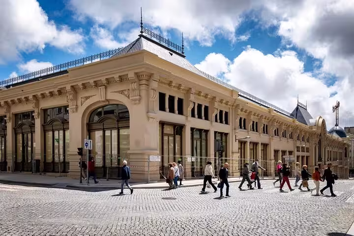 Tourists explore the historic architecture of Porto during a private full-day tour from Lisbon, showcasing cultural landmarks.