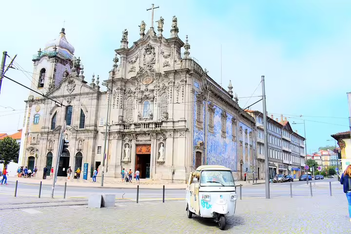 Explore Porto's historic center with a private tuk tuk tour, passing by the stunning Igreja do Carmo with its iconic azulejos.