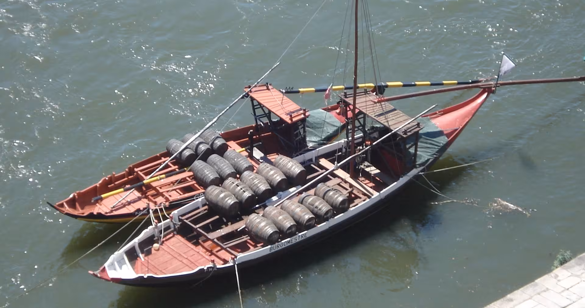Traditional Douro rabelo boat with port wine barrels on the river, seen on Porto half-day walking tour